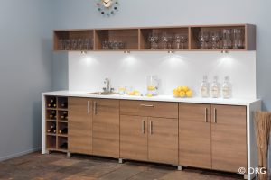 brown wall shelves with wine glasses and cabinets