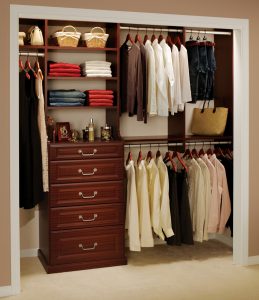 brown drawer base with clothing racks and shelves
