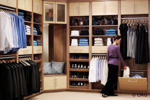 walk in closet with girl looking at clothes