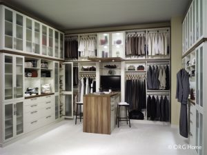 A neatly organized, custom-built walk-in closet with extra storage and organizational space.