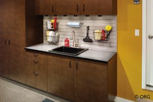 brown wood cabinets with black countertop and peg board