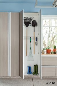custom shelves with door open and rake inside
