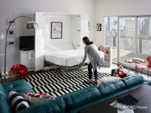 woman pulls out murphy bed