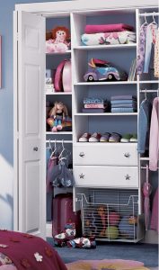 white closet door with shelves and storage for children's toys