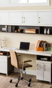 white drawers with black shevling and desk space with chair