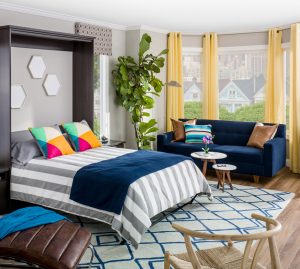murphy bed with colorful bedspread and couch