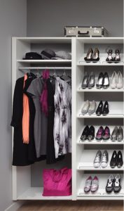 white shelving system with coats and pink bag